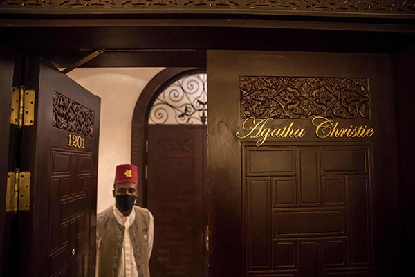 An employee of the Old Cataract Hotel stands through the door of the suite where British crime fiction writer Dame Agatha Christie is believed to have stayed while writing her 1937 novel “Death on the Nile”, in Egypt’s southern city of Aswan. (AFP)